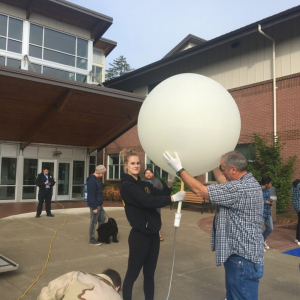 students prepare weather balloon
