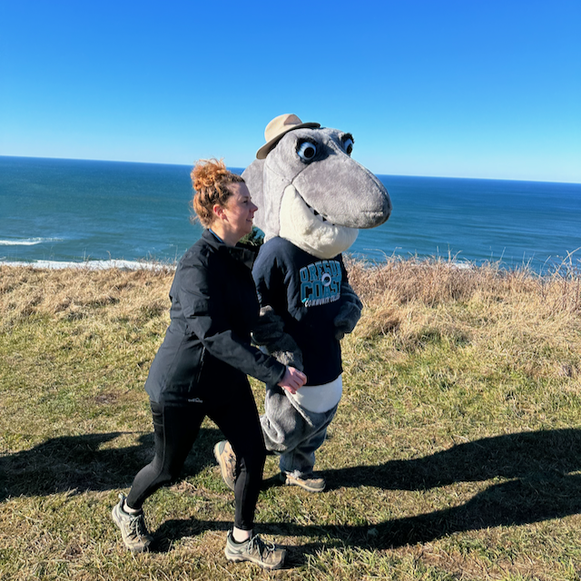 Oregon Coast mascot hiking on The Knoll overlooking Lincoln City with Jeanne Sprague