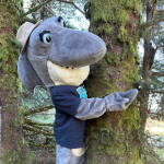 Oregon Coast mascot hugging a tree in Lincoln City