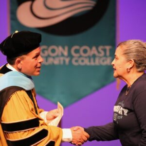 President Roache congratulates Tatiana Wong, ESOL student