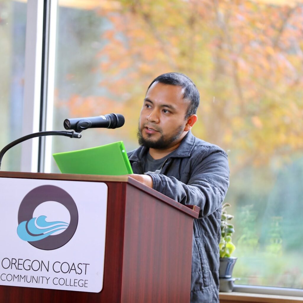 Joel Lorenzo speaking at a podium