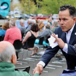 President greets a guest at outdoor event