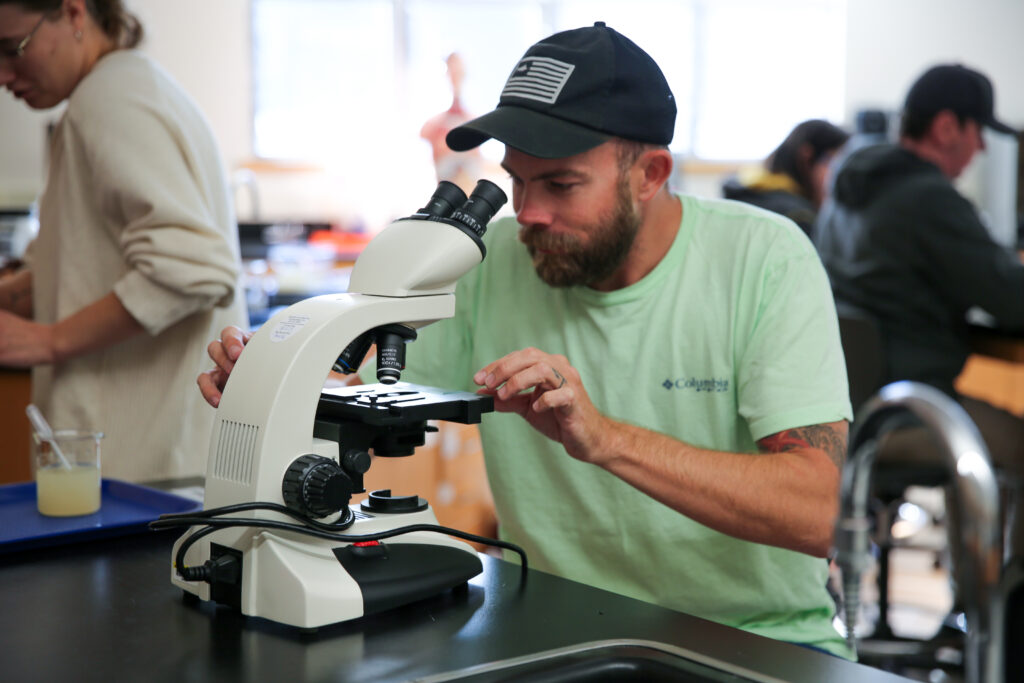 Student looking into a microscope