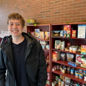 Student stocking the Lincoln City Shark Shack Annex